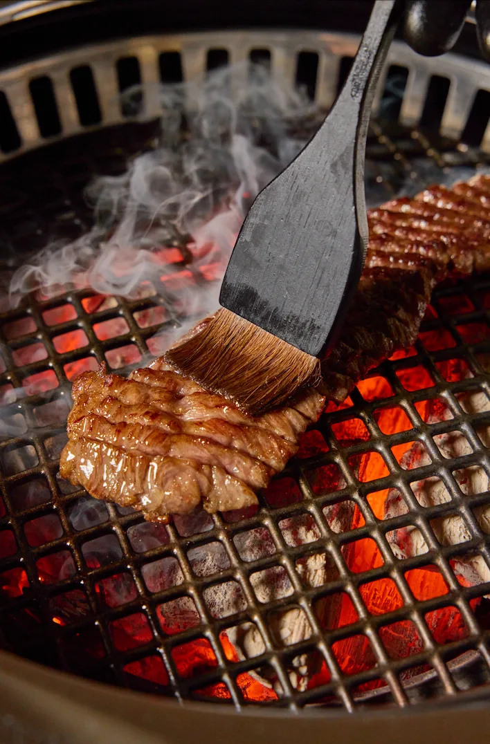 Marinated galbi being brushed over charcoal at Seolya